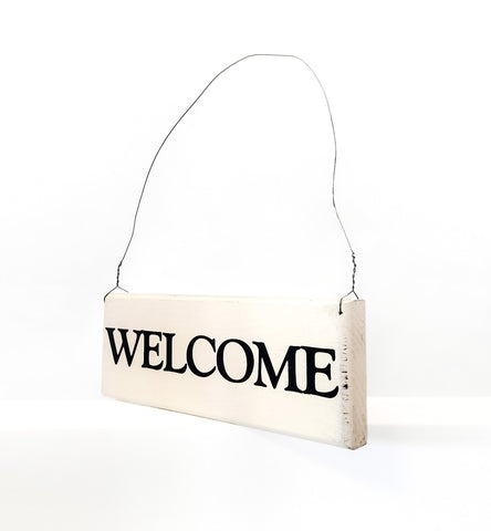 Welcome wood sign with saying